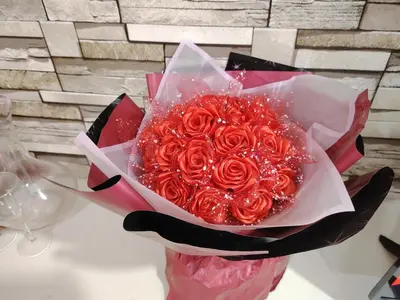 a bouquet of red roses on a table at KL studio with Private Jacuzzi in Kuala Lumpur