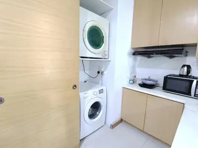 a kitchen with a washing machine and a microwave at KL studio with Private Jacuzzi in Kuala Lumpur