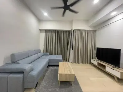 a living room with a blue couch and a flat screen tv at STAR Suites Residence KLCC in Kuala Lumpur