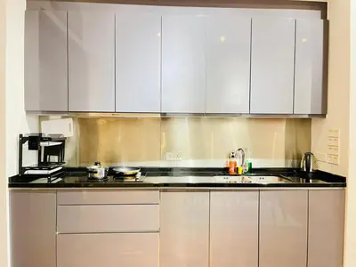 a kitchen with white cabinets and a sink at KLCC Service Suites at Mews in Kuala Lumpur