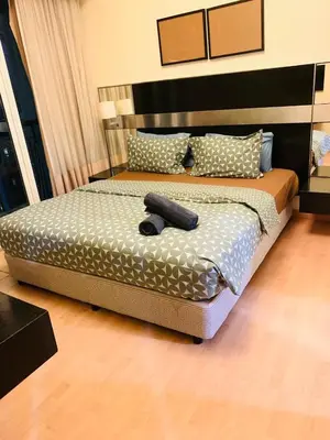 a bedroom with a bed with a black object on it at Bukit bintang central seri Bukit Ceylon in Kuala Lumpur