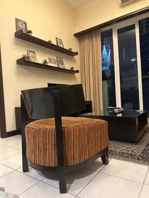 a living room with a chair and a table at Bukit bintang central seri Bukit Ceylon in Kuala Lumpur