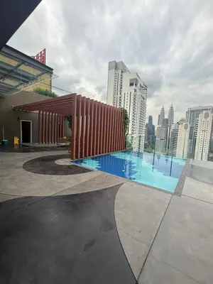 a swimming pool on the roof of a building at Majestic Residence KLCC Sky view in Kuala Lumpur