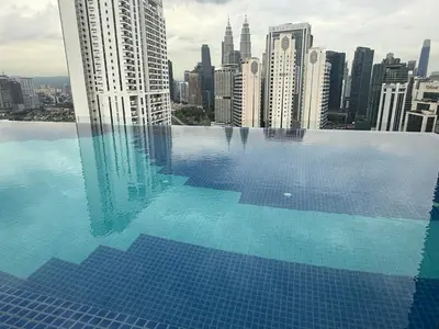 a swimming pool with a view of a city at Majestic Residence KLCC Sky view in Kuala Lumpur