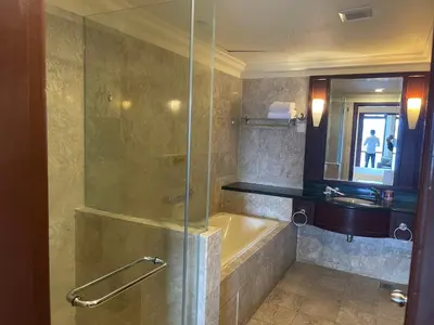 a bathroom with a shower and a tub and a sink at City view Apartment at Times square in Kuala Lumpur