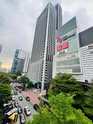 a busy city street with cars parked in front of buildings at Elite Hotel KL Sentral in Kuala Lumpur