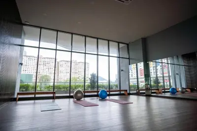 a room with yoga mats in front of a large window at 2PAX-4PAX Projector Screen Stay near KLCC & Jelatek LRT Station in Kuala Lumpur