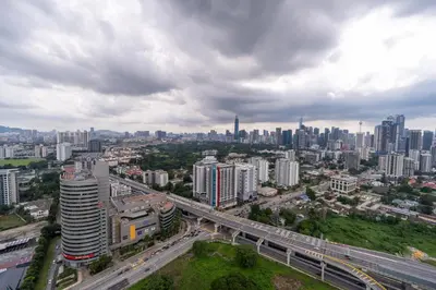 an aerial view of a city with a highway at 2PAX-4PAX Projector Screen Stay near KLCC & Jelatek LRT Station in Kuala Lumpur