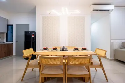a kitchen and dining room with a wooden table and chairs at Cherished Moments Hub M Vertica 12pax Family in Kuala Lumpur