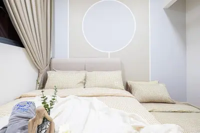 a bedroom with a bed with white sheets and a window at Cherished Moments Hub M Vertica 12pax Family in Kuala Lumpur