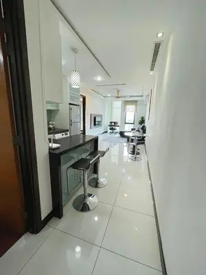 a kitchen with a counter and stools in a room at Casa Residency Apartment Bukit Bintang by Cupid home in Kuala Lumpur
