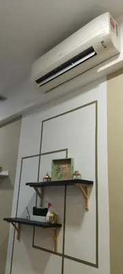 a light hanging from a ceiling with a shelf at Sky Touch Homestay in Kuala Lumpur