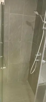 a bathroom with a shower with a glass door at Sky Touch Homestay in Kuala Lumpur