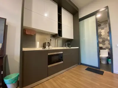 a kitchen with a sink and a microwave at Ceylonz suites Klcc by StayLa in Kuala Lumpur