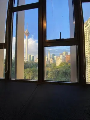 a view of a city skyline from a window at Ceylonz suites Klcc by StayLa in Kuala Lumpur