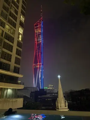 a tower lit up in red and blue at night at Robertson Residence in Kuala Lumpur in Kuala Lumpur