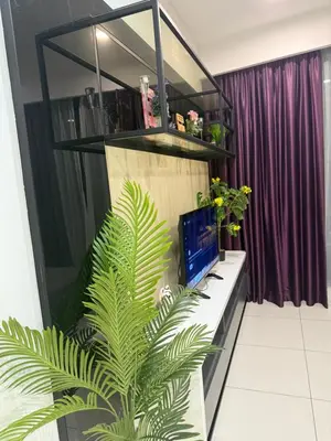 a desk with a computer and a plant in a room at Robertson Residence in Kuala Lumpur in Kuala Lumpur