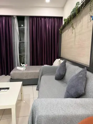 a living room with two beds and a table at Robertson Residence in Kuala Lumpur in Kuala Lumpur