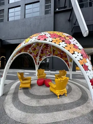 a group of chairs sitting under an umbrella at Cosy Place in Kuala Lumpur