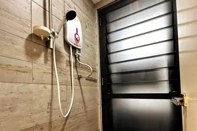 a shower head on the wall of a bathroom at Cosy Place in Kuala Lumpur