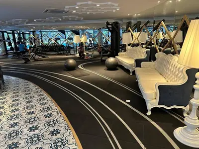 a gym on a cruise ship with white chairs at Cosy Place in Kuala Lumpur
