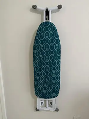 a green and white skateboard hanging on a wall at Cosy Place in Kuala Lumpur
