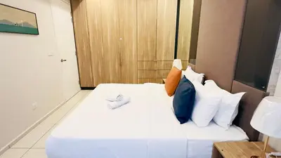 a bedroom with a white bed with colorful pillows at Balcony Cityscape V The Robertson Residence 36f in Kuala Lumpur
