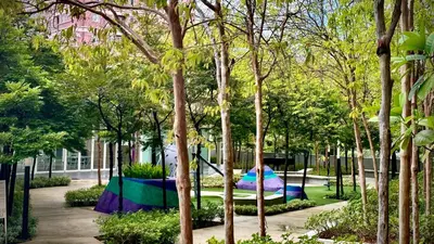 a park with a playground in the middle of trees at Balcony Cityscape V The Robertson Residence 36f in Kuala Lumpur
