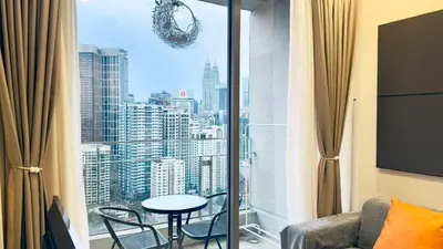 a room with a large window with a table and chairs at Balcony Cityscape V The Robertson Residence 36f in Kuala Lumpur