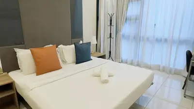 a white bed with a cross on top of it at Balcony Cityscape V The Robertson Residence 36f in Kuala Lumpur