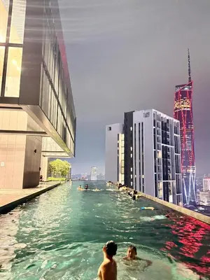 two men in the water in a city with buildings at Lucentia residence by lalaport in Kuala Lumpur