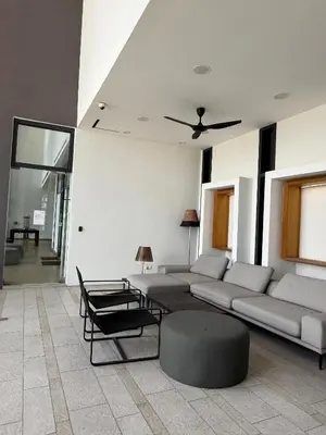 a living room with a couch and a table at Lucentia residence by lalaport in Kuala Lumpur