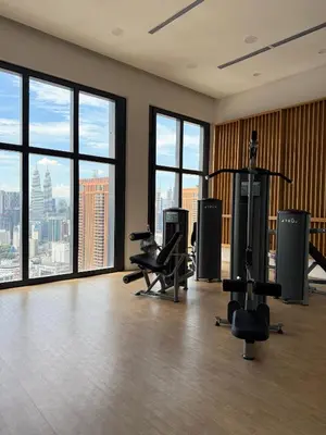 an empty gym with a view of the city at Lucentia residence by lalaport in Kuala Lumpur