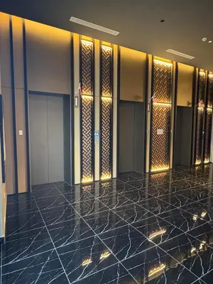 a hallway of a hotel with a marble floor and elevators at Ubays Majestic House in Kuala Lumpur
