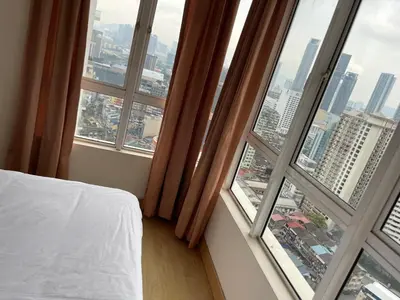 a bedroom with a bed and a large window at Kuala Lumpur city centre in Kuala Lumpur
