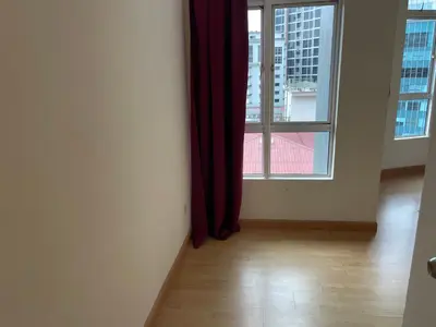 an empty room with a window with red curtains at Kuala Lumpur city centre in Kuala Lumpur