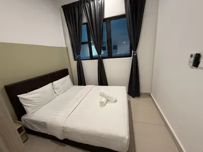 a bedroom with a bed with white sheets and a window at Trion Residence Kuala Lumpur By A&B in Kuala Lumpur