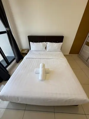 a roll of toilet paper sitting on top of a bed at Trion Residence Kuala Lumpur By A&B in Kuala Lumpur