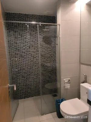 a bathroom with a glass shower with a toilet at 0108 Casa Residency- Sweet Home 2R 2B in Kuala Lumpur