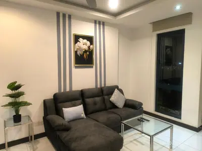 a living room with a couch and a glass table at 0108 Casa Residency- Sweet Home 2R 2B in Kuala Lumpur
