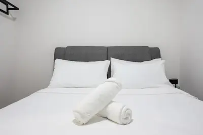 a white bed with a stuffed animal on it at M Vertica Residences by The Clover, Maluri , Cheras , Kuala Lumpur , KLCC, Free Parking in Kuala Lumpur
