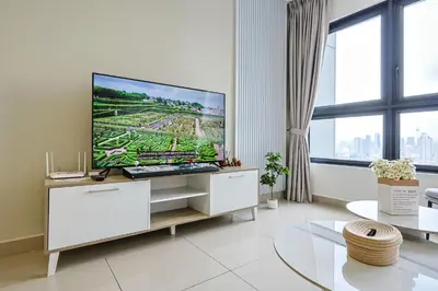 a living room with a large flat screen tv at M Vertica Residences by The Clover, Maluri , Cheras , Kuala Lumpur , KLCC, Free Parking in Kuala Lumpur