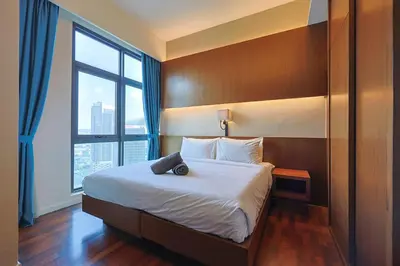 a bedroom with a large bed with a large window at 8 min walk to Pavilion KL - Infinity Pool w TRX view in Kuala Lumpur