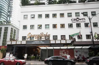 a large white building with a sign on it at Soho Suites @ KLCC by Luxury Suites Asia in Kuala Lumpur