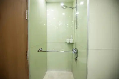 a shower with a glass door in a bathroom at Soho Suites @ KLCC by Luxury Suites Asia in Kuala Lumpur
