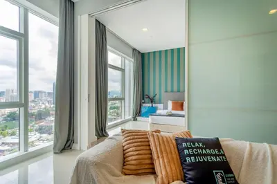 a living room with a couch and large windows at Platinum near KLCC Kuala Lumpur in Kuala Lumpur