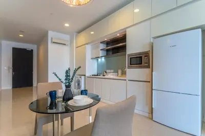 a kitchen with a glass table and a refrigerator at Platinum near KLCC Kuala Lumpur in Kuala Lumpur