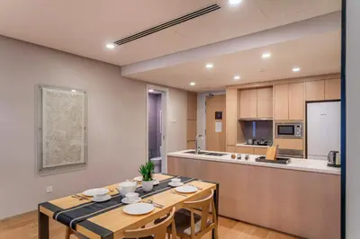 a dining room with a table and a kitchen at 188 Suites near KLCC with Parking and Bathtub in Kuala Lumpur