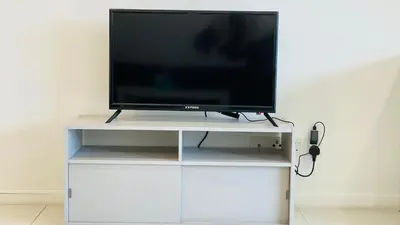 a flat screen tv sitting on a white entertainment center at Summer Suites KLCC BY Lotus in Kuala Lumpur