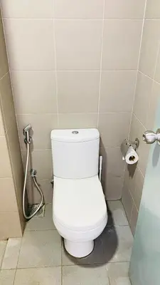 a bathroom with a white toilet in a stall at Summer Suites KLCC BY Lotus in Kuala Lumpur